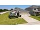 Traditional home with a two-car garage, manicured shrubs, and a well-kept lawn enhancing its curb appeal at 3702 Maidencain St, Clermont, FL 34714