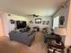 Cozy living room featuring comfortable seating, a ceiling fan, and abundant natural light, ideal for relaxation at 3702 Maidencain St, Clermont, FL 34714