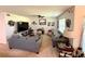 Comfortable living room with plush sofas, a ceiling fan, and neutral decor, creating an inviting gathering space at 3702 Maidencain St, Clermont, FL 34714