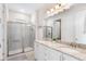 Bright bathroom with granite countertops, double sinks, and a glass-enclosed shower at 416 Southfield St, Kissimmee, FL 34747