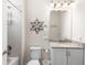 Well-lit bathroom with granite countertops, a tub, and decorative wall art at 416 Southfield St, Kissimmee, FL 34747