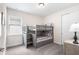 Cozy ' bedroom with grey bunk beds, carpet, and a large window at 416 Southfield St, Kissimmee, FL 34747