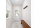 Inviting entryway with a bench, decorative glass door, and light gray walls at 416 Southfield St, Kissimmee, FL 34747