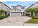 Charming two-story home with a stone accented garage and paver driveway at 416 Southfield St, Kissimmee, FL 34747