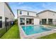 Backyard features a sparkling pool and spa with a black fence at 416 Southfield St, Kissimmee, FL 34747