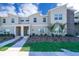 Inviting townhome exterior with manicured landscaping, modern design and a stone accent wall detail at 4188 Paragraph Dr, Kissimmee, FL 34746