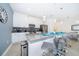 Modern kitchen with stainless steel appliances, a large island with seating, and pendant lighting at 4188 Paragraph Dr, Kissimmee, FL 34746