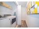 Modern laundry room with front load washer dryer and ample shelving space at 4188 Paragraph Dr, Kissimmee, FL 34746