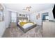 Serene primary bedroom featuring a king-sized bed, neutral tones, and an en-suite bathroom at 4188 Paragraph Dr, Kissimmee, FL 34746