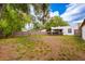 Expansive backyard featuring a wooden fence, patio, and mature trees at 420 N Center St, Eustis, FL 32726