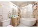 Cozy bathroom with a tub, pebble accent wall, and modern vanity sink at 420 N Center St, Eustis, FL 32726