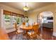 Charming dining room with hardwood floors, a round wooden table, and a decorative chandelier at 420 N Center St, Eustis, FL 32726