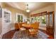 Traditional dining room featuring a wooden table, china cabinet, and an abundance of natural light at 420 N Center St, Eustis, FL 32726