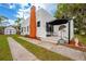Charming home showcasing stucco walls, an outdoor seating area, and well-maintained landscaping at 420 N Center St, Eustis, FL 32726