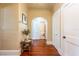 Hallway with textured walls, a wooden bench, and a view to an arched doorway at 420 N Center St, Eustis, FL 32726