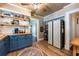 Charming kitchen features wood countertops, blue cabinets, and stylish open shelving at 420 N Center St, Eustis, FL 32726