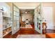 Stylish home office with French doors, patterned wallpaper, and a comfortable rocking chair at 420 N Center St, Eustis, FL 32726