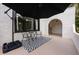 Outdoor patio with an umbrella, table, and chairs situated on a patterned rug at 420 N Center St, Eustis, FL 32726