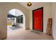 Inviting arched porch entrance with a striking red door and outdoor seating area at 420 N Center St, Eustis, FL 32726