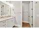 Bright bathroom featuring a granite countertop vanity, chrome fixtures, and wood look flooring at 441 N Capen Ave, Winter Park, FL 32789