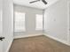 Neutral carpeted bedroom with a ceiling fan and two windows providing natural light at 441 N Capen Ave, Winter Park, FL 32789