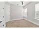 Neutral carpeted bedroom with a ceiling fan and two windows offering ample natural light at 441 N Capen Ave, Winter Park, FL 32789