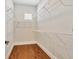 Walk-in closet with hardwood floors, built in shelving, and a window for natural light at 441 N Capen Ave, Winter Park, FL 32789