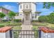Charming two-story home featuring brick accents and decorative black metal fence with a paved walkway at 441 N Capen Ave, Winter Park, FL 32789