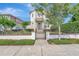 Charming two-story home with manicured lawn, brick accents, and a secure, decorative black metal fence at 441 N Capen Ave, Winter Park, FL 32789
