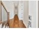 Bright hallway with hardwood floors and white walls, leading to doorways, providing a modern aesthetic at 441 N Capen Ave, Winter Park, FL 32789