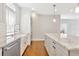 Bright kitchen featuring granite counters, white cabinets, stainless steel appliances, and hardwood flooring at 441 N Capen Ave, Winter Park, FL 32789