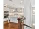 Modern kitchen with white cabinetry, an island, and stainless steel appliances, creating a spacious atmosphere at 441 N Capen Ave, Winter Park, FL 32789