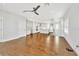 Bright living room with hardwood floors, connecting to a kitchen with white cabinetry and an island at 441 N Capen Ave, Winter Park, FL 32789