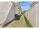 A narrow side yard features manicured grass and access gate at 441 N Capen Ave, Winter Park, FL 32789