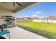 Cozy patio overlooking a spacious backyard with a swing set at 445 Auburn Grove Pl, Auburndale, FL 33823