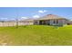 Large backyard featuring a swing set, lush green grass and privacy fence at 445 Auburn Grove Pl, Auburndale, FL 33823