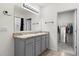 Bathroom featuring a double vanity with granite countertop and walk-in closet at 445 Auburn Grove Pl, Auburndale, FL 33823