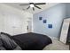 Relaxing bedroom featuring a comfortable bed, soft lighting, storage and a large mirror at 445 Auburn Grove Pl, Auburndale, FL 33823