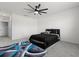Bright bedroom featuring a ceiling fan, gray carpet and white walls at 445 Auburn Grove Pl, Auburndale, FL 33823