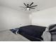Bright bedroom featuring a ceiling fan, gray carpet and white walls at 445 Auburn Grove Pl, Auburndale, FL 33823