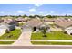 Charming single-story home with well-maintained lawn, complemented by an attached garage and inviting curb appeal at 445 Auburn Grove Pl, Auburndale, FL 33823