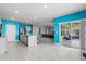 Bright, open-concept kitchen featuring a center island with a stainless steel dishwasher and access to an outdoor patio at 445 Auburn Grove Pl, Auburndale, FL 33823