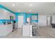 Stylish kitchen with gray cabinets, a center island with seating, stainless steel appliances, and white tile flooring at 445 Auburn Grove Pl, Auburndale, FL 33823