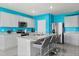 Modern kitchen with gray cabinets, granite countertops, stainless steel appliances, and a center island with bar seating at 445 Auburn Grove Pl, Auburndale, FL 33823