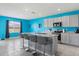 Bright kitchen featuring a spacious island with barstool seating, stainless steel appliances, and ample counter space at 445 Auburn Grove Pl, Auburndale, FL 33823