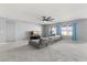Cozy living room featuring a comfortable sectional sofa, large windows, and a ceiling fan at 445 Auburn Grove Pl, Auburndale, FL 33823