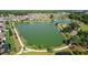 Aerial view of a community pond with walking path and surrounding homes and green spaces at 459 Dancing Water Dr, Winter Springs, FL 32708