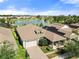 Stunning aerial view of a lakeside home featuring solar panels and a paver driveway, situated in a vibrant community at 459 Dancing Water Dr, Winter Springs, FL 32708