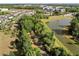An aerial view shows a community with tree lined streets, walking paths and waterways in a scenic neighborhood at 459 Dancing Water Dr, Winter Springs, FL 32708