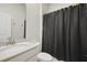 Neutral bathroom features modern fixtures, a vanity, and a shower with a dark shower curtain at 459 Dancing Water Dr, Winter Springs, FL 32708